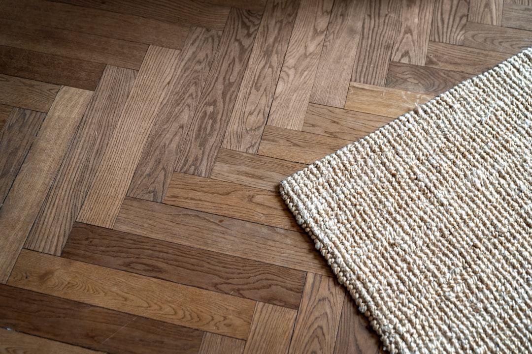A close up of a rug on a wooden floor
