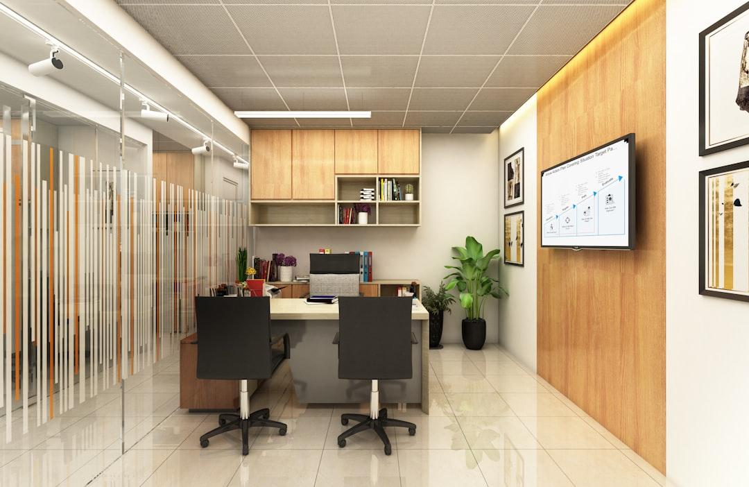 Modern office with desks and wood accents.