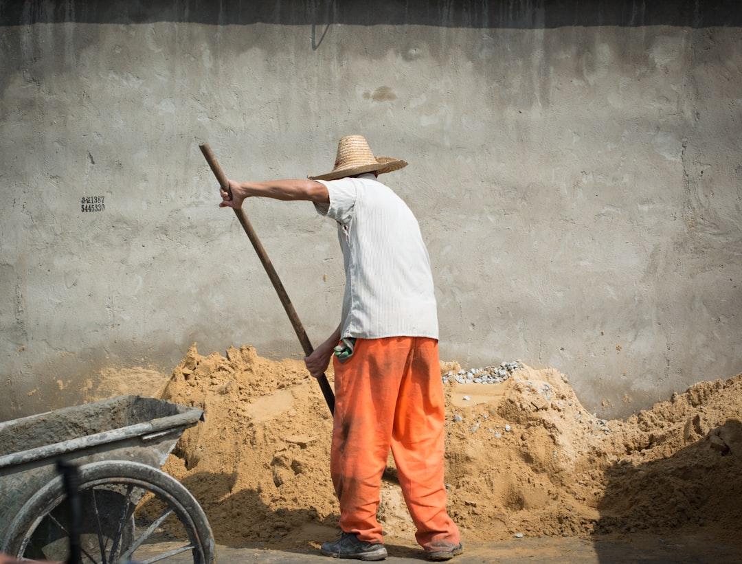man raking the sand