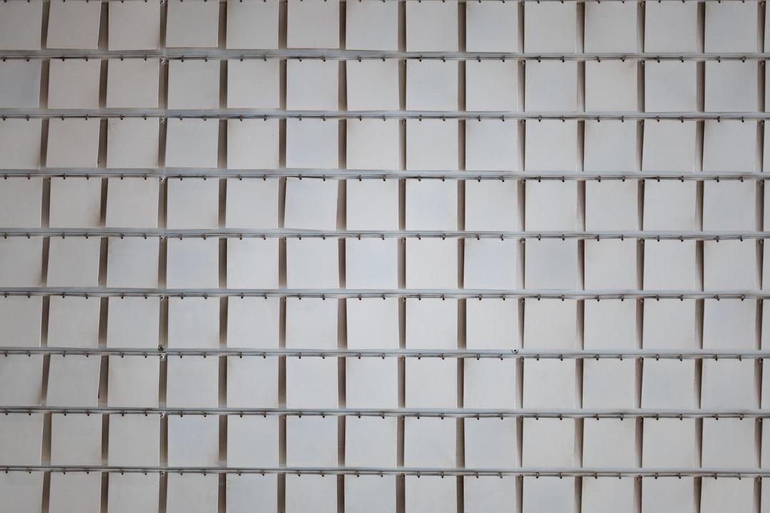 A close up of a white tiled wall