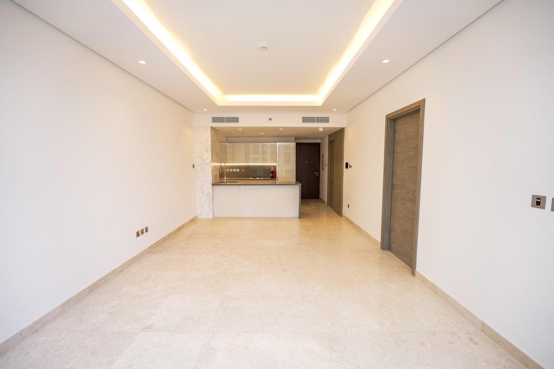 An empty room with white walls and a ceiling light