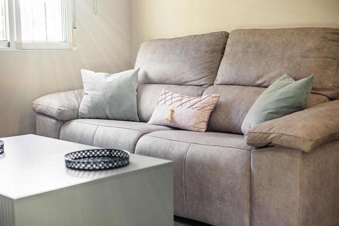 A comfortable sofa with decorative pillows and a coffee table.