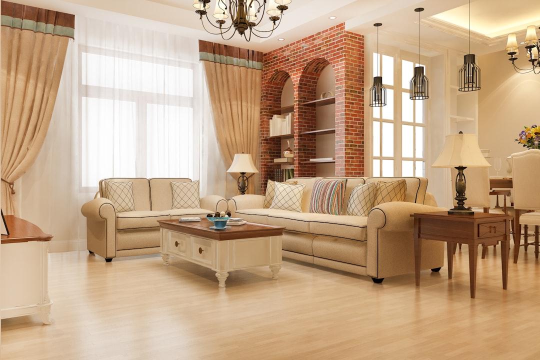 Elegant living room with plush sofas and brick accent wall.