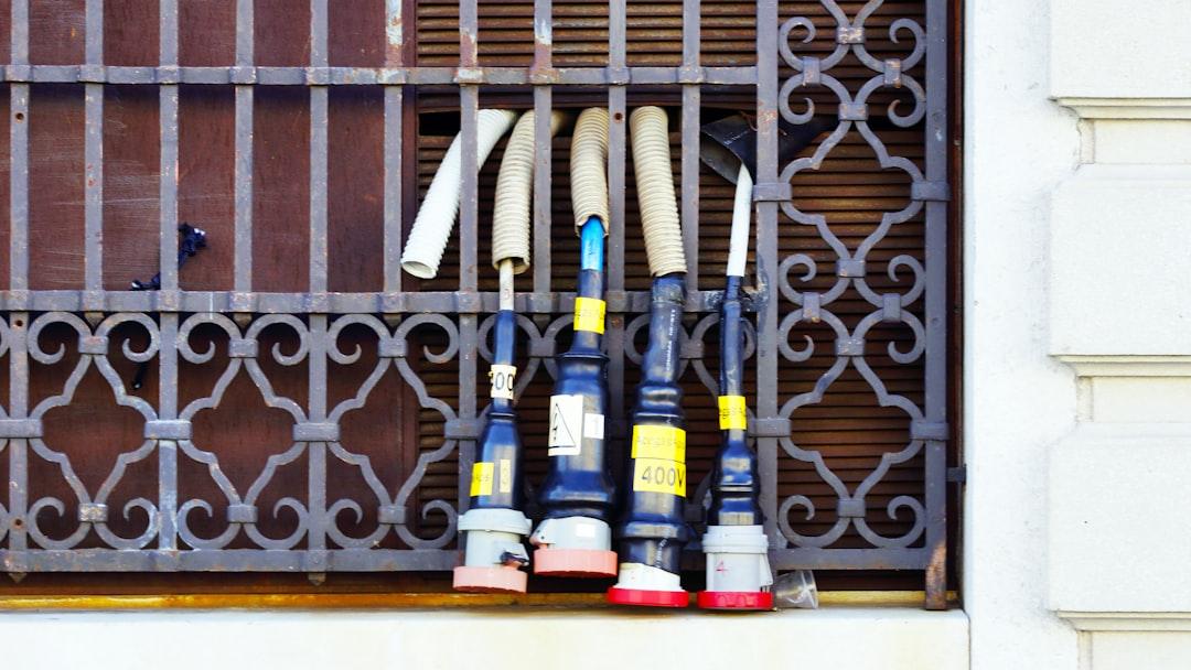 A bunch of baseball bats sitting on a window sill