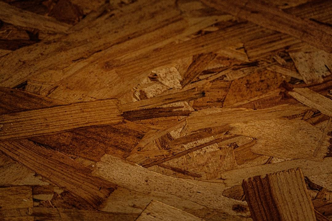 Close-up of a textured wooden particle board surface.