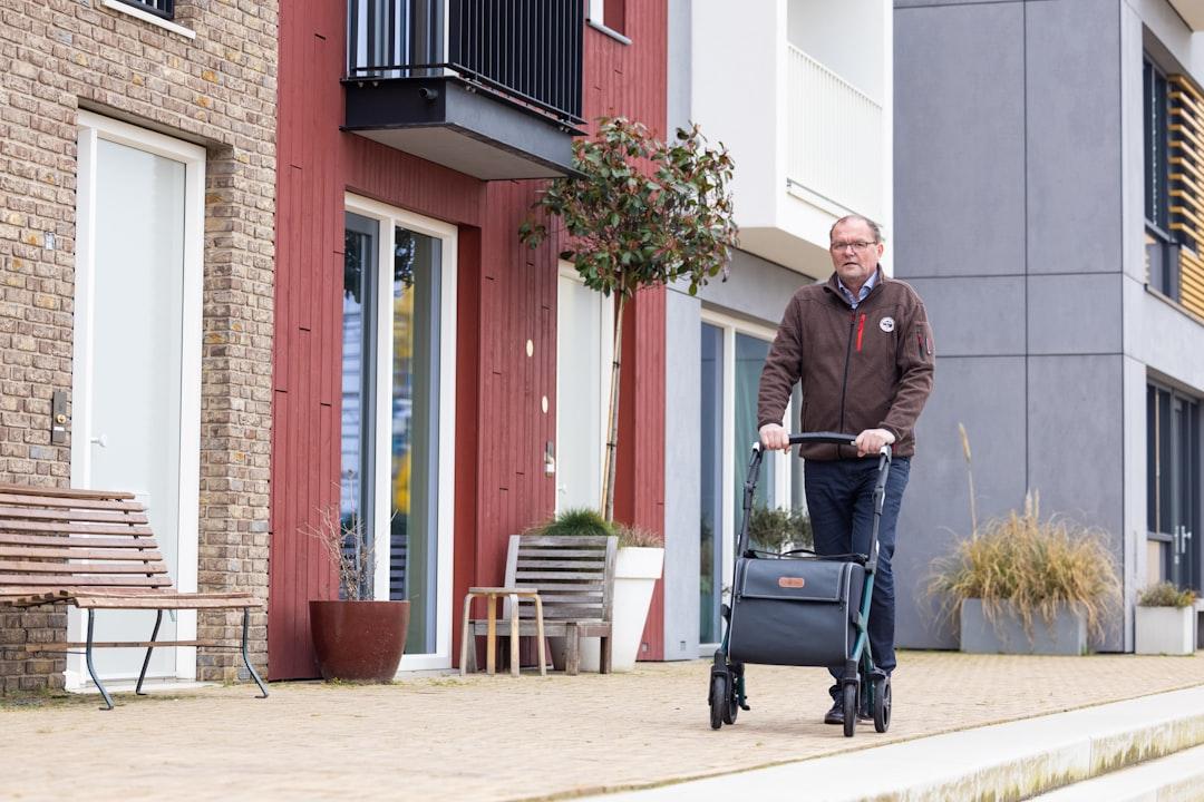 a man pushing a luggage cart down a street