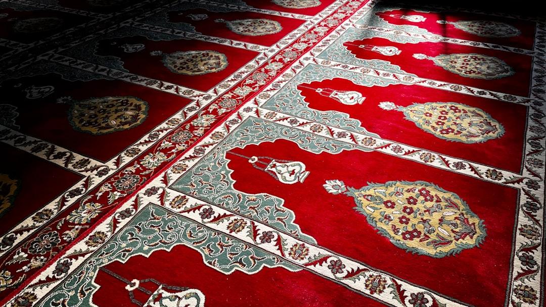 a red rug with a pattern on it