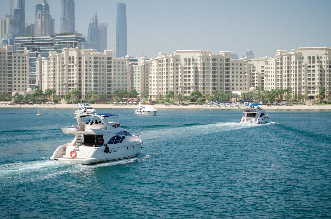 a group of boats in the water near a city